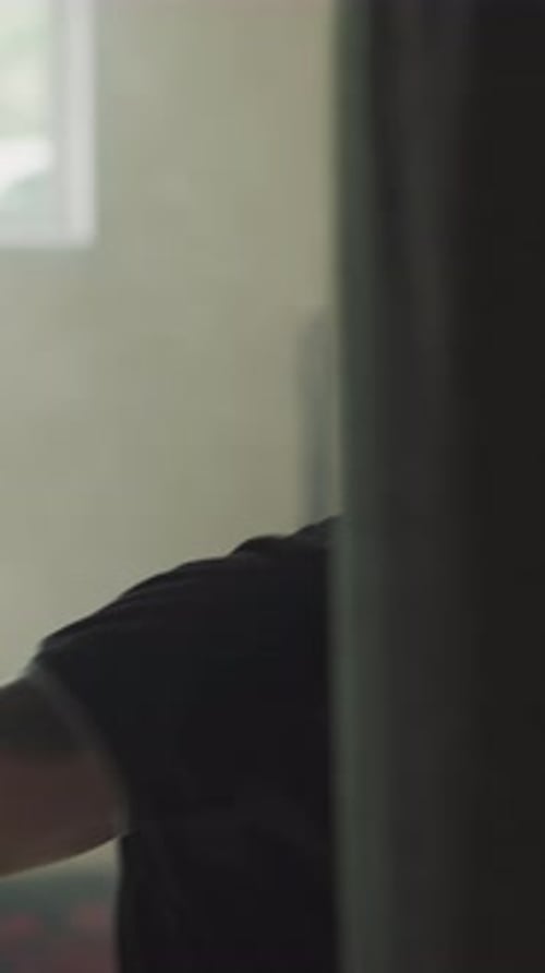 Young man in gym boxing punching bag workout