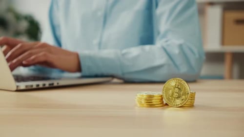 Close Up of Gold BTC Coins That Successful Young Woman Hold at Home