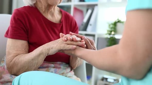 Gentle Hands Offer Comfort to Senior Woman