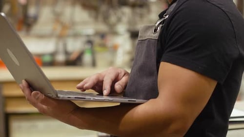 Close Up Male Carpenter Using Laptop in Workshop 3539 Years