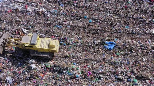 City landfill with trucks and compactors at work