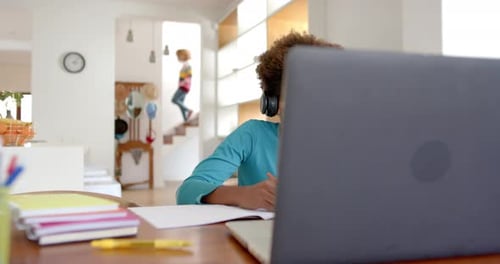 Boy with Headphones Learning at a Computer