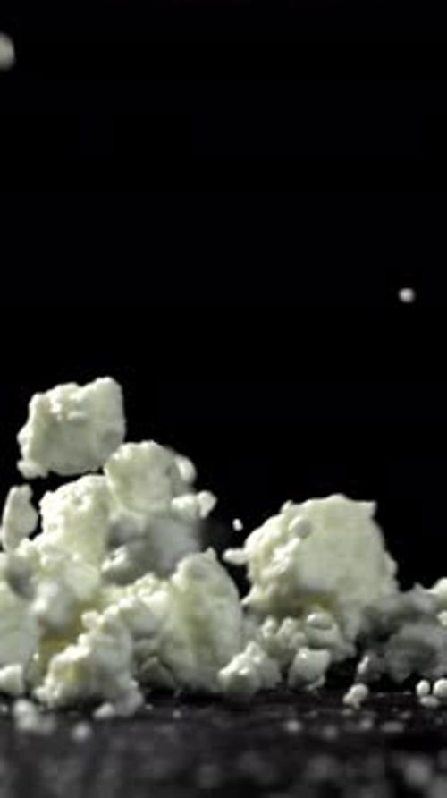 Fresh Cottage Cheese Falling on Black Background Filmed on a Highspeed Camera at 1000 Fps