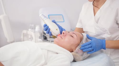 Woman Receives Facial Treatment at Medical Spa