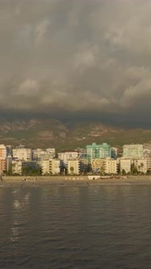 Vertical Video Sunset Magic Unfolds Over the Mediterranean Sea with a Fishing Boat Drifting Near a