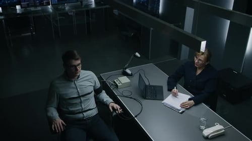 Man Taking Lie Detector Test with Woman Interviewer