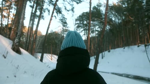 Female Walks in Beautiful Winter Forest