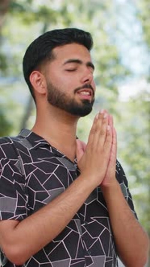 Man Hands Together In Prayer in a Park