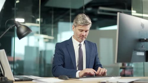Excited Businessman Celebrating Success at Office Computer