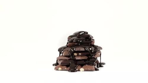 Stack of Chocolate Slices Covered in Sauce