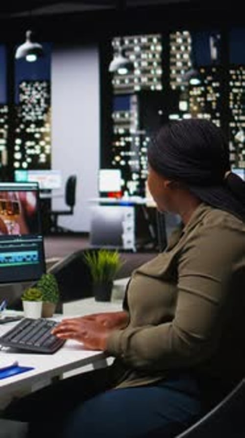 Woman Working Late at Computer in Office