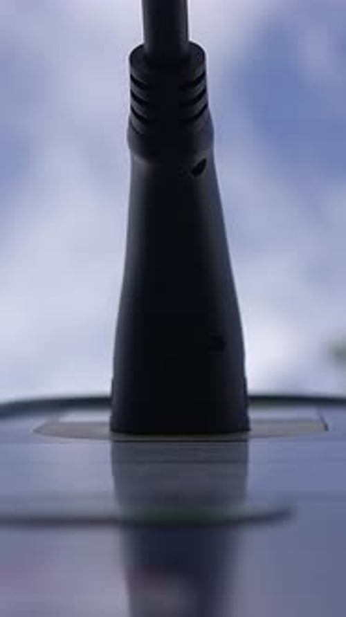 A CloseUp Image of a Black Connector Set Against the Beautiful Blue Sky Background