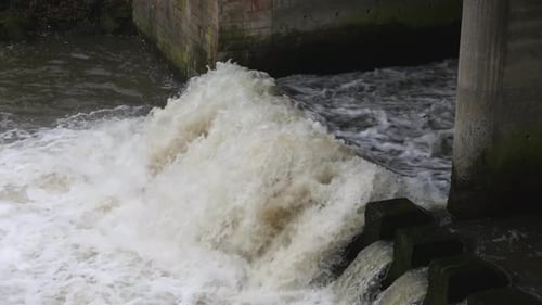 Fast moving water moving over a weir.