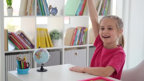 Smart Little Girl Raising Hand at School