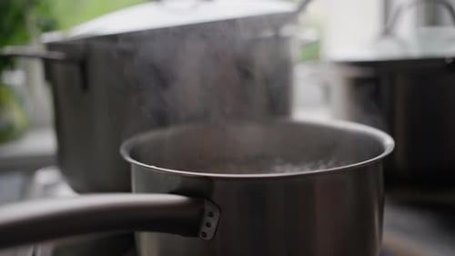 Pots Boiling on the Stove in Kitchen