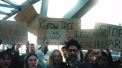 Crowd Protesting War with Signs and Raised Fists