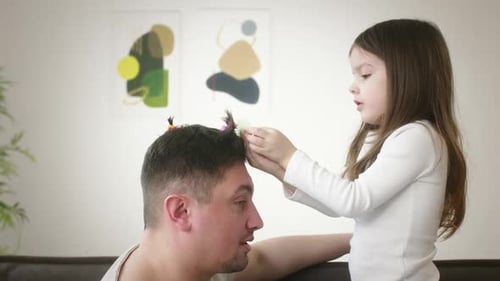 Girl Gives Dad Silly Hairstyle at Home