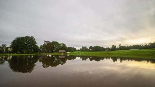 Going from spring to summer, autumn and winter in a time lapse of a lake with a holiday home.