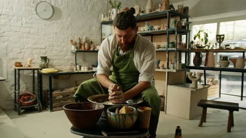 A man makes a clay pot on a ceramic wheel Ceramics Close-up A potter does pottery handicraft