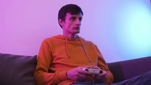 Young Adult Gamer on Couch with Controller