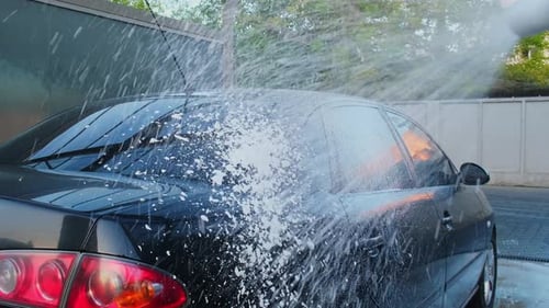Washing Luxury Black Car on Touchless Car Wash Cleaning the Details of Car Washing Sedan Car with