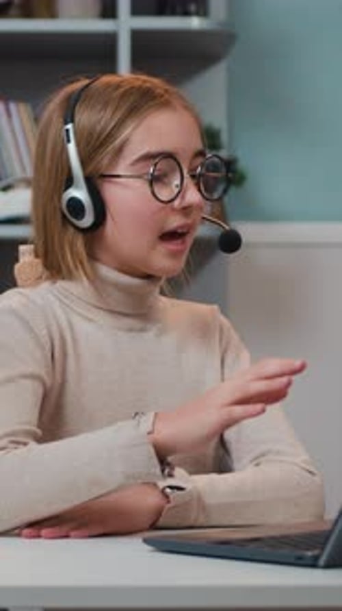 Child with Headset Using Laptop in Home Setting