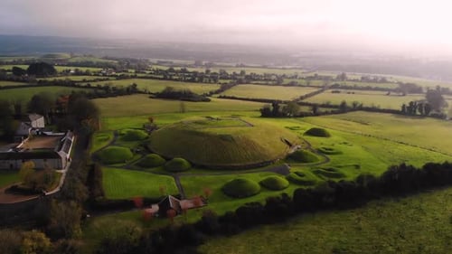 Knowth, Neolithic passage grave aerial orbit shot. Ancient monument located in Ireland. World Herita