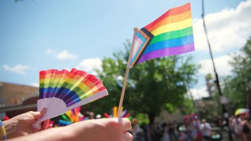 Colorful Pride Flags Waving at Lively Parade