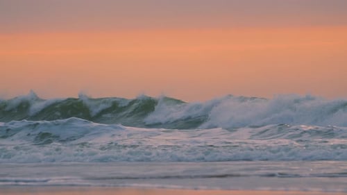 Sunrise Ocean Slow Motion Footage of Powerful Waves Arriving on Beach with Orange Sunlight