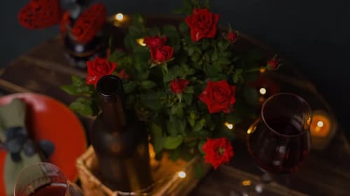 Romantic Dinner Table Setting with Wine and Roses