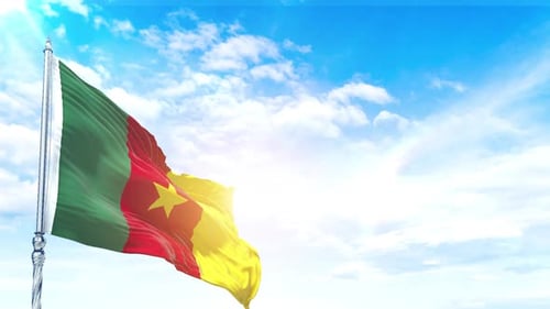 Cameroon National Flag Waving Proudly Against Bright Blue Sky