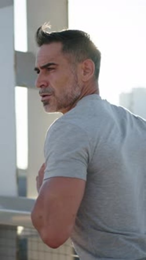 Back View of Mature Grey Athlete Male Person Running on Sunny Modern Urban Bridge