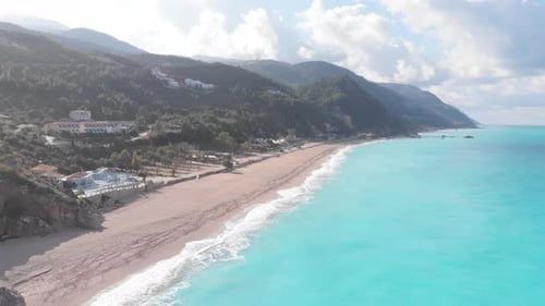 Aerial beautiful beach and water bay in the greek spectacular coast line. Turquoise blue transparent