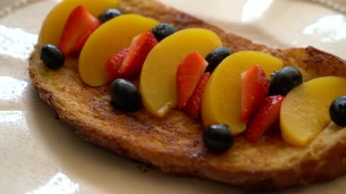 french toast with peach, strawberry and blueberries