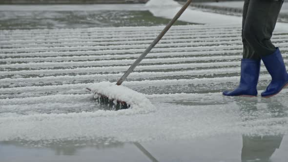 Salt Worker Raking the Harvest in Salt Field, Industrial Stock Footage ...