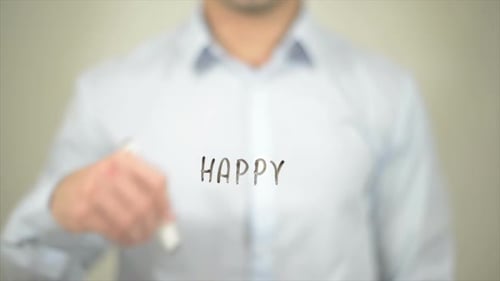 Man Writes the Word Happy on Screen