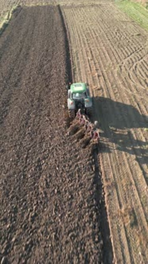 Tractor Plows Land In The Field Aerial