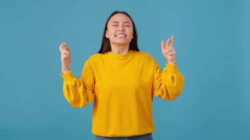 Woman Making Please Gesture and Expressing Triumph in Studio