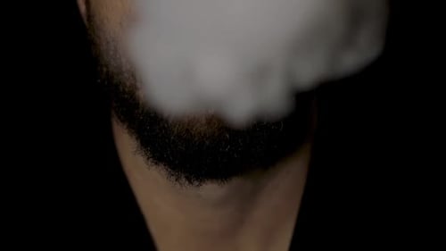 Close Up of Man Exhaling Large Vapor Cloud