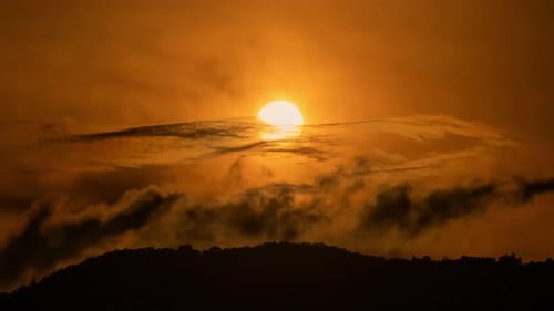 Scenic Sunset Over Hill with Clouds in Sky