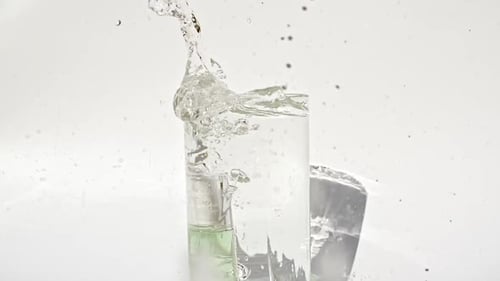 Bottle Dropped in Water Glass Causing a Splash