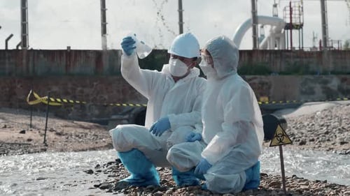 Ecologist Sampling Water Toxic Chemicals From River with Test Tube Glass and Have White Smoke