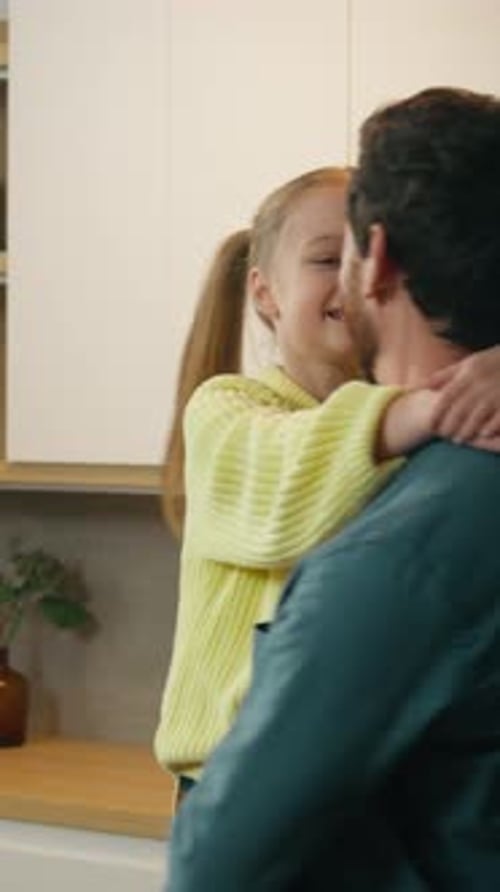 Loving father holds and embraces his little daughter