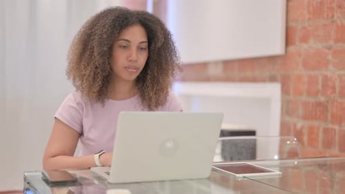 African American Woman Working on Laptop