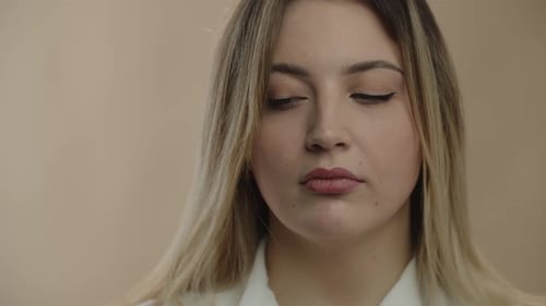 Closeup View of Woman with Extra Weight Rubbing Her Face Portrait of Exhausted Blonde Girl Isolated