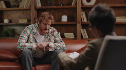 Man Talking With Therapist During Counseling Session