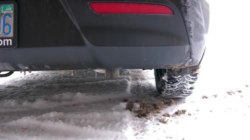 Car Idling in Snow on Winter Road