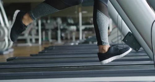 A beautiful woman, runs on the treadmill, to keep fit and be toned or lose weight.