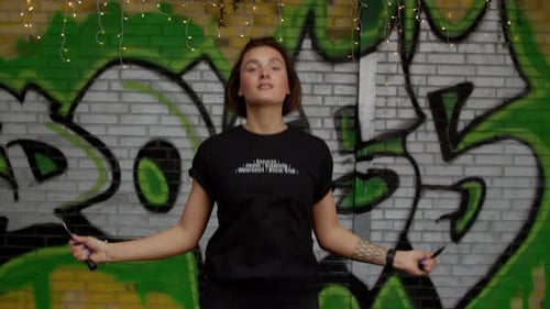 Woman trains and jumps rope, coordination training, crossfit training day in the gym, strength fit b