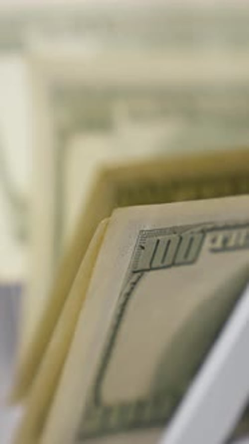 Cash money counting equipment. Currency counting machine counting dollar banknotes.